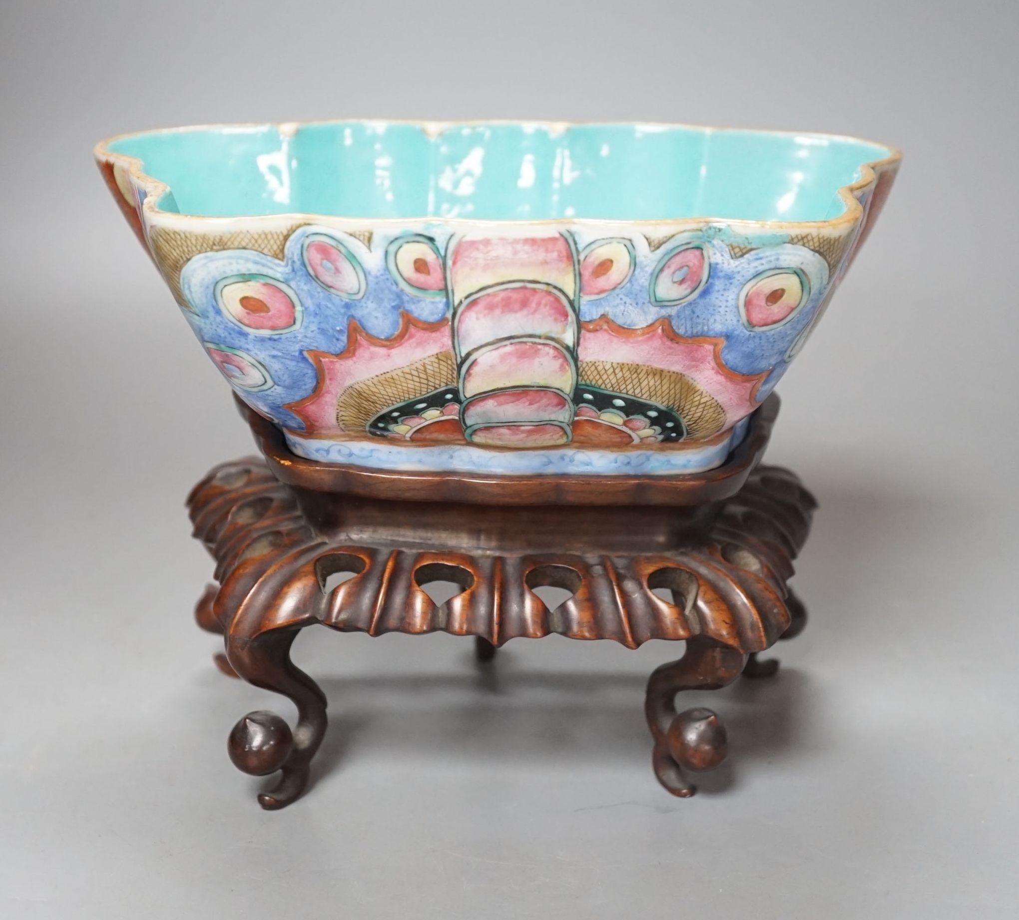 A 19th century Chinese enamelled porcelain ‘butterfly’ bowl, hongmu stand, 21 cms wide x 8 cms high.